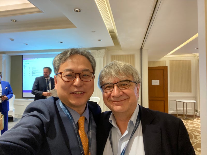 With a fellow speaker